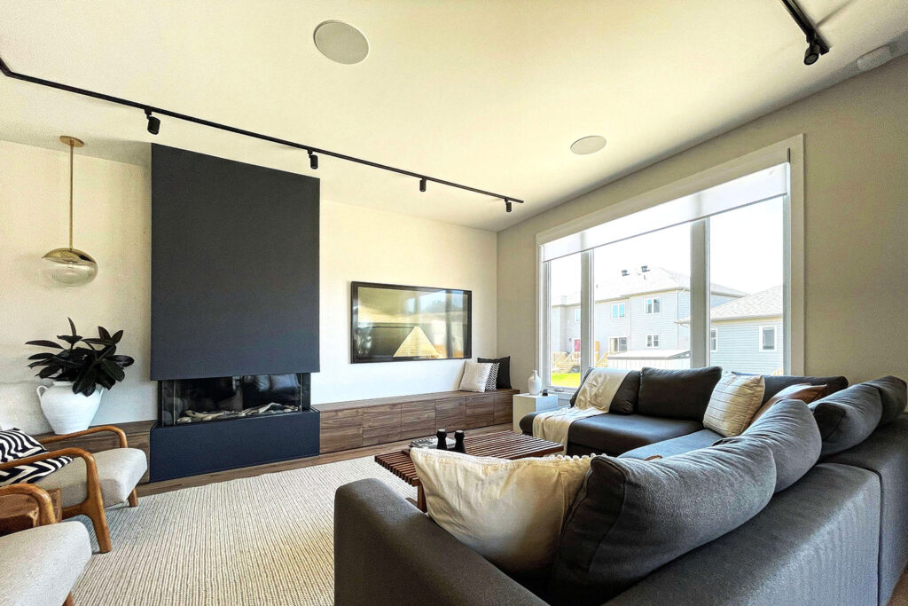 A living room with in-ceiling speakers and a smart tv