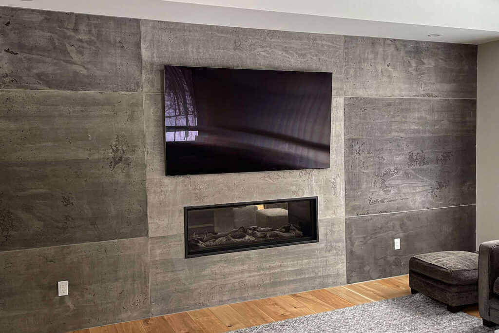 an entertainment room with a nicely installed tv on a wall.